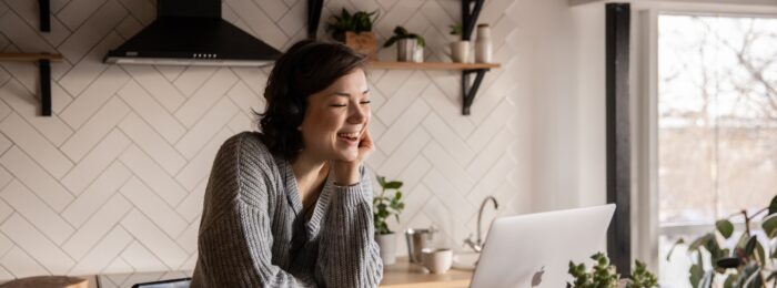 What to look for in student accomodation Woman in the kitchen with a laptop